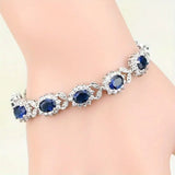 TENNIS FLOWER OVAL SAPPHIRE BLUE HALO PAVÉ BRACELET | SILVER JEWELLERY